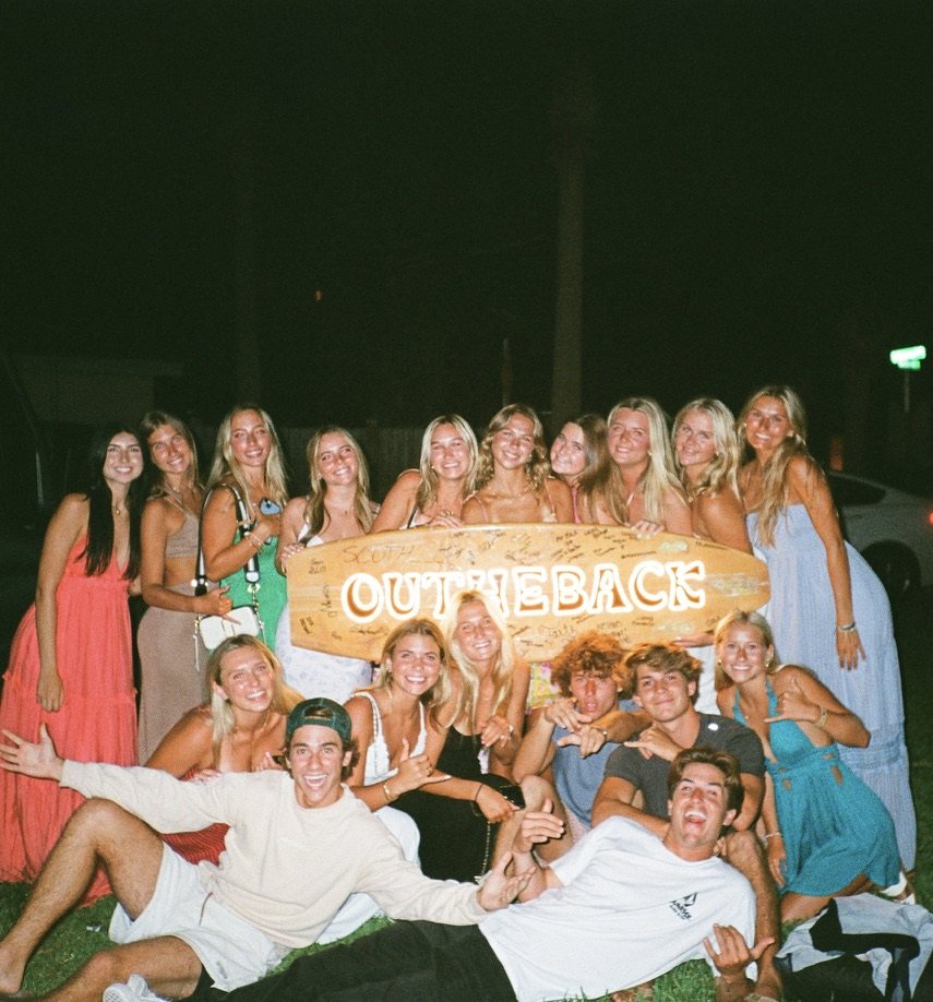 the crew with a signed out the back board