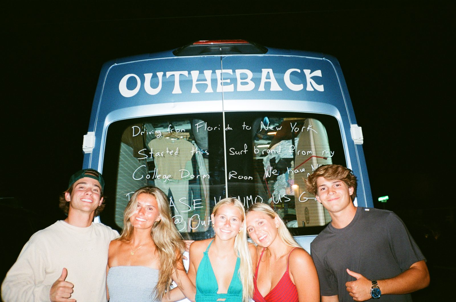 the out the back crew in front of the van